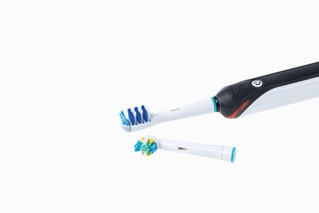Two kinds of head and toothbrush close up view isolated. Health care concept.の写真素材