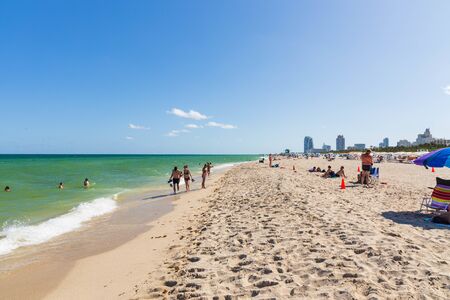 Beautiful landscape view of Miami South Beach coast line. Sand beach, Atlantic Ocean, people on blue sky background. USA Miami Beach. 24/09/2019.のeditorial素材