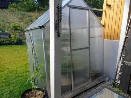 Close up view of of greenhouse on backyard. Gardening concept.の写真素材