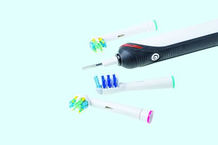 Three kinds of head and toothbrush close up view isolated on blue background. Health care concept.の写真素材