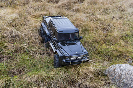 View of radio controlled model racing car on off-road background. Toys with remote control. Free time. Children and adults concept. Uppsala. Sweden 02.16.2020.のeditorial素材