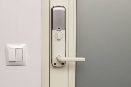 Close up view of an electric combination lock on a white door. Interior design. Beautiful backgrounds.の写真素材