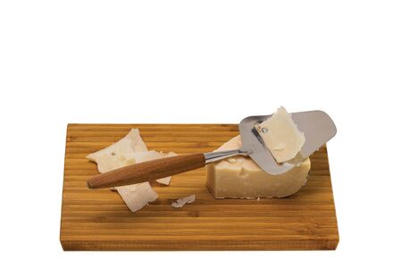 Close up view of cheese with cheese knife isolated on wooden board. Healthy food concept.の写真素材