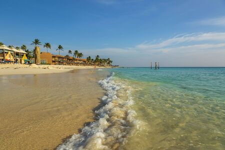 White sand beach and turquoise waves. Amazing beauty Eagle Beach of Aruba Island. Beautiful nature background.の写真素材