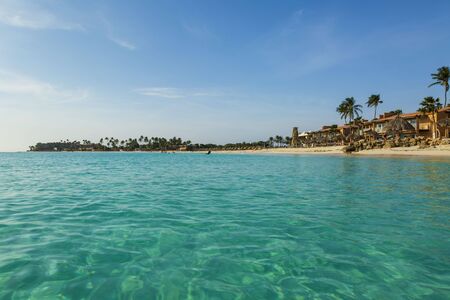 Amazing beauty white sand beach of Aruba Island. Turquoise sea water and blue sky. Caribbean. Unforgettable view.の写真素材