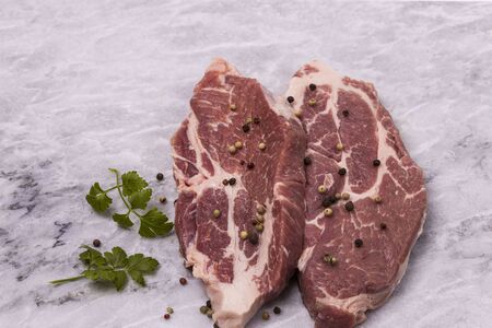 Close up view of raw pork steaks with spices isolated. Food concept.の写真素材