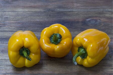Close up view of fresh yellow paprika isolated on wooden background. Healthy eating concept.の写真素材