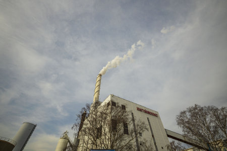 Beautiful view of CHP building on blue sky with white clouds background. Combined heat and power...