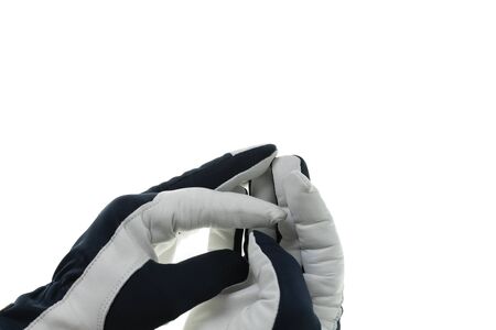Close up view of black and white leather nylon gloves on hands.の写真素材