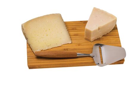 Close up view of different kinds of cheese with cheese knife isolated on wooden board. Healthy food concept.の写真素材