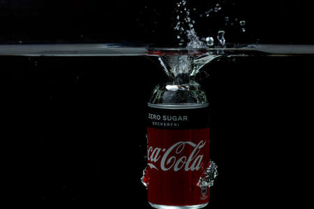 Close up view of can falling in water. Coca cola. Sweden Uppsala. 14/03/2020.のeditorial素材