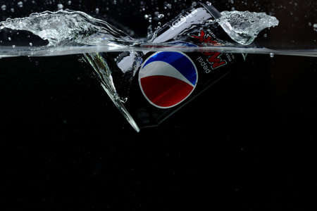 Close up view of can falling in water. Pepsi Cola. Sweden Uppsala. 14/03/2020.のeditorial素材