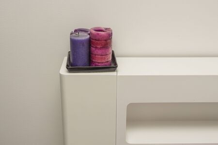 Close up view of purple candles on white headboard. Interior decoration concept.の写真素材