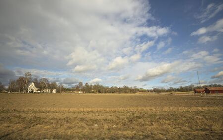 Beautiful landscape view with fields, forest trees and blue sky with white clouds. Gorgeous spring backgrounds.の写真素材