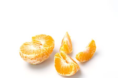 Close up macro view of whole and peeled mandarin on white background. Organic food concept. Healthy food concept.の写真素材
