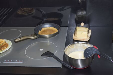 Close up view of baking pancakes at home on induction cooker. Healthy eating concept.の写真素材