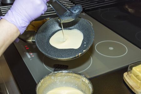 Close up view of baking pancakes at home on induction cooker. Healthy eating concept.の写真素材