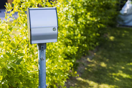 Close up view of outdoor power outlet isolated on green plants background. Technology concept.の写真素材