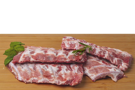 Close up view of raw pork ribs on wooden cutting broad. Cooking and food concept.