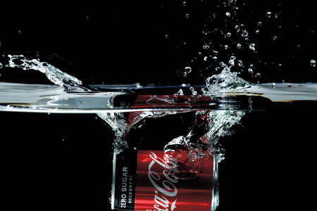 Close up view of coca falling in water on black background. Gorgeous backgrounds. 11.27.2020. Uppsala. Sweden.のeditorial素材