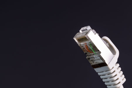 View of cable network connection, internet communication and computer technology concept isolated on black background.の写真素材