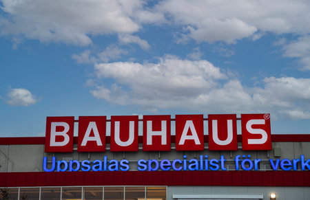 Close up view of logo board Bauhaus on blue sky with white clouds background. Sweden. Uppsala. 12.20.2020.のeditorial素材