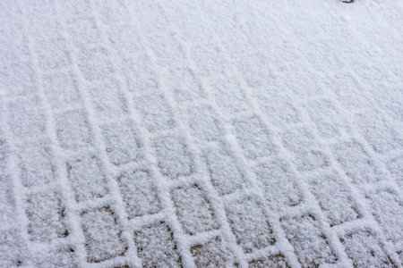 Close up view of beautiful snow covered paving slabs. Winter pattern texture concept.の写真素材