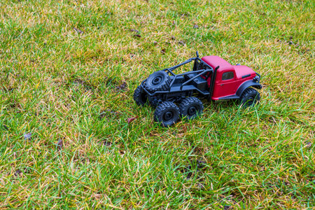 Red model car on lawn.