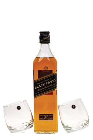 Beautiful view bottle whiskey and two elegant whiskey glasses on background. Beautiful backgrounds. Alcohol concept. Uppsala. Sweden. 09/01/2021.のeditorial素材