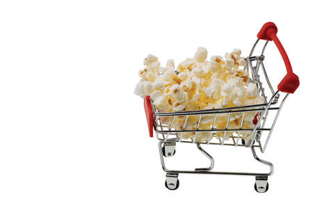 Close up view of popcorn in shopping cart on white background isolated. Unhealthy food concept.の写真素材