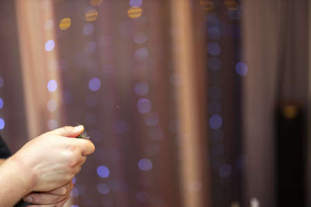 Close up view of male hands opening bottle of wine. Holidays. Alcohol.の写真素材