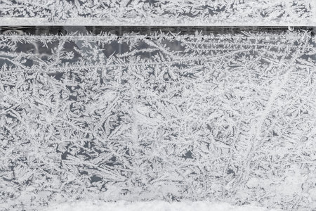 Gorgeous view through frozen window. Beautiful winter background texture.