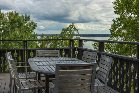 Overview of outdoor wooden veranda around private house with gorgeous landscape on Baltic sea....