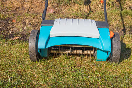 Close up view of electric lawn aerator on green grass isolated. Garden machines concept. Sweden.の写真素材