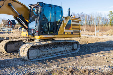Close up view of construction excavator on outdoor construction place on spring blue sky background....