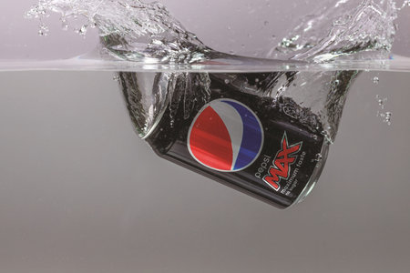 Close up view of can falling in water. Pepsi Cola. Sweden. Uppsala. 03.21.2021.
