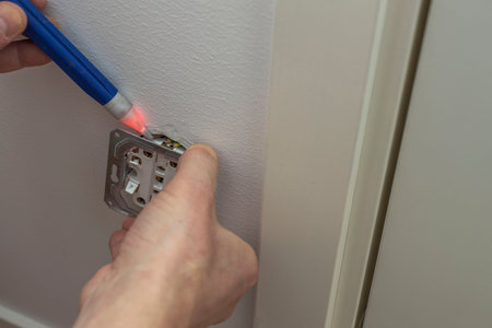 Close up view of man checks voltage in the electrical outlet. Sweden.