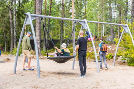 Parents with children are relaxing in a children's amusement park on a summer day. Europe. Kolmorden, Sweden. 09.28.2020.のeditorial素材