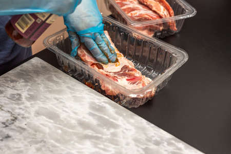 Close up view of pork ribs being with bbq marinade. Food and health concept.の写真素材