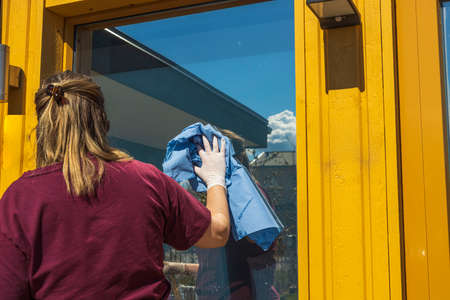 Close up view of woman cleaning window. Sweden.の写真素材