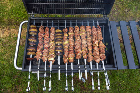 Close up view of barbecue skewer grilling process. Food and health concept. Sweden.の写真素材