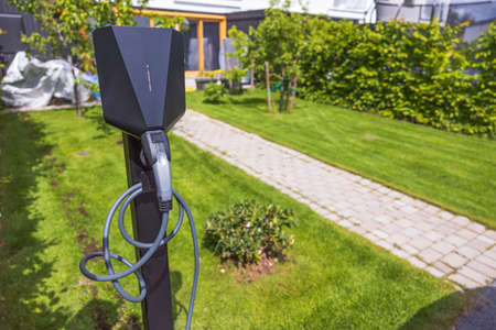 Close up view of charging station for electric car in front yard of townhouse. Sweden.の写真素材