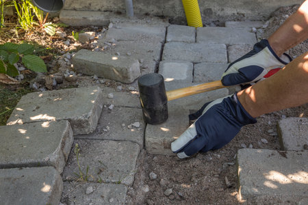 Close up view of man laying paving slabs. Sweden.の写真素材
