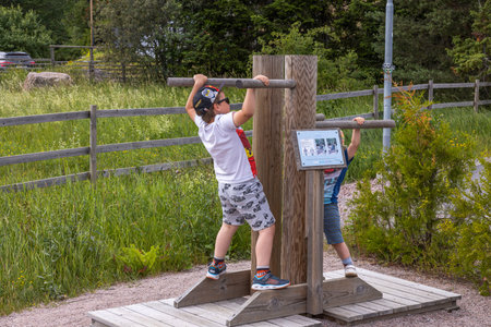 View of two boys playing on playground on sunny summer day. Sweden. Uppsala. 06.27.2021.