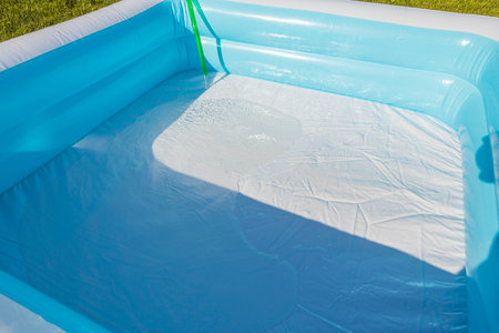Close up view of filling play pool with water processing. Sweden.