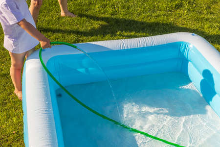 Close up view of filling play pool with water processing. Sweden.の写真素材