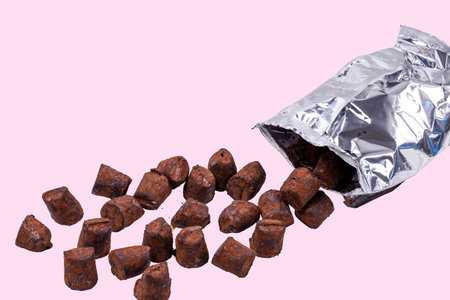 View of truffle candy on pink background isolated.