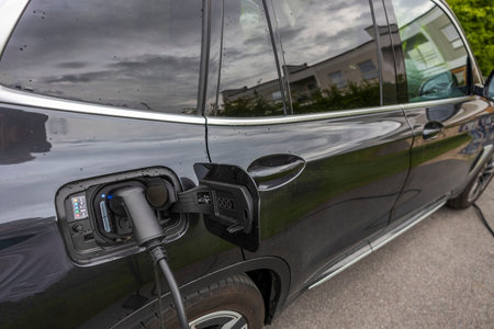Close up view of electric vehicle with charging cable. Sweden.