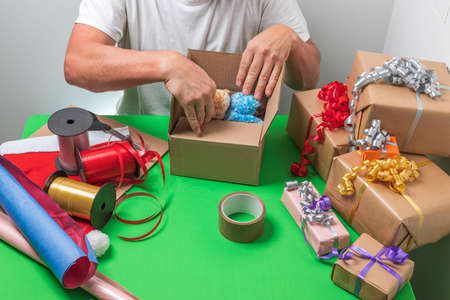 Beautiful view of man packing Christmas gifts. Christmas holiday concept. Postcard. Sweden.の写真素材