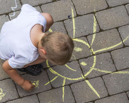 Beautiful top-down view on child drawing with chalk on paving slabs. Sweden.の写真素材